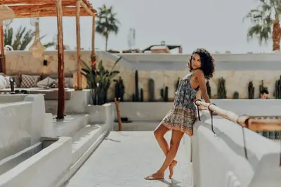 a woman in a dress standing next to a wall at Kenzara Suites & Pool, Your private escape in Marrakech