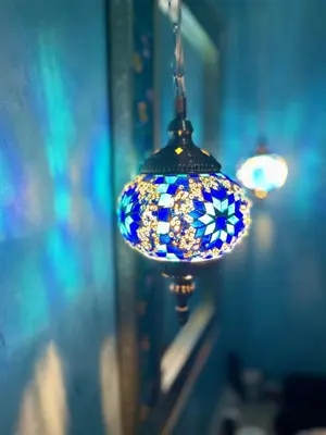 a blue and white lamp hanging from a wall at Kenzara Suites & Pool, Your private escape in Marrakech