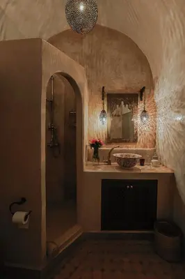 a bathroom with a shower and a sink and a mirror at Kenzara Suites & Pool, Your private escape in Marrakech