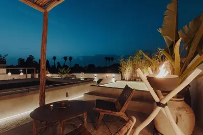 a patio with a table and chairs on a roof at Kenzara Suites & Pool, Your private escape in Marrakech
