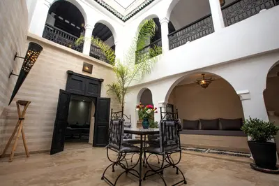 a room with a table and chairs in a building at Riad RIM in Marrakech