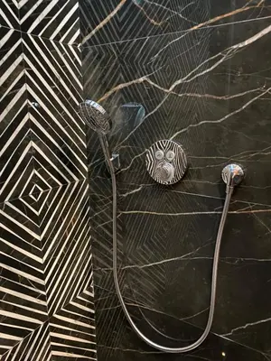 a shower with a hose attached to a wall at Oasi Marrakech in Marrakech
