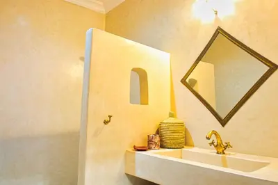 a bathroom with a sink and a mirror at Riad Al Wifak in Marrakech