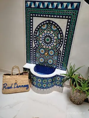 a bathroom with a mosaic toilet with a bag at Riad Darnooz Marrakech in Marrakech