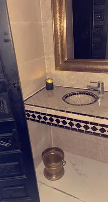 a bathroom with a sink and a mirror at Riad Darnooz Marrakech in Marrakech