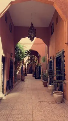 an empty hallway with plants in a building at Riad Darnooz Marrakech in Marrakech
