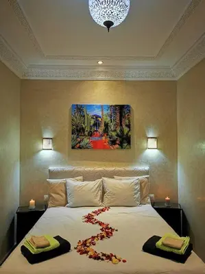 a bedroom with a large bed with flowers on it at Maison de standing - Médina de Marrakech in Marrakech