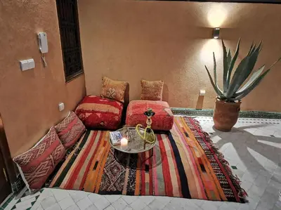 a living room with a couch and a table at Maison de standing - Médina de Marrakech in Marrakech