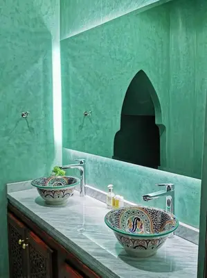 two sinks on a counter in a green bathroom at Maison de standing - Médina de Marrakech in Marrakech
