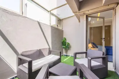a patio with two chairs and a table at NEW! Plein Gueliz, terrasse, wifi in Marrakech
