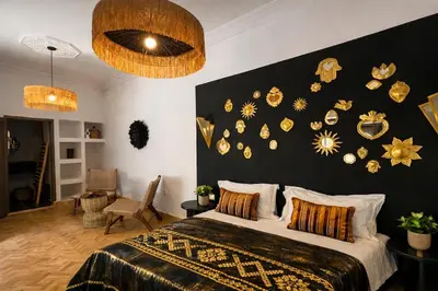 a bedroom with a bed with a black and gold wall at RIAD JOUJ- Oasis privée avec bassin et SPA - kasbah in Marrakech