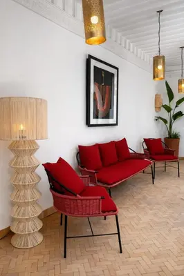 a living room with red chairs and a red couch at RIAD JOUJ- Oasis privée avec bassin et SPA - kasbah in Marrakech