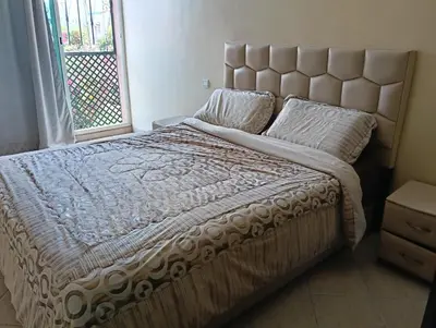 a bedroom with a large bed with a large window at Au centre,Charmant appartement dans un quartier chic et calme, Très bon emplacement in Marrakech