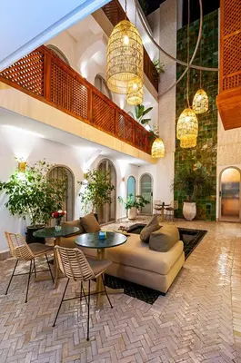 a living room with a couch and a table and chairs at RIAD DAR BAYANE in Marrakech