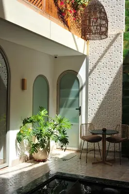 a patio with a table and chairs and a pool at RIAD DAR BAYANE in Marrakech