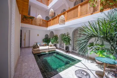 a living room with a swimming pool in a house at RIAD DAR BAYANE in Marrakech