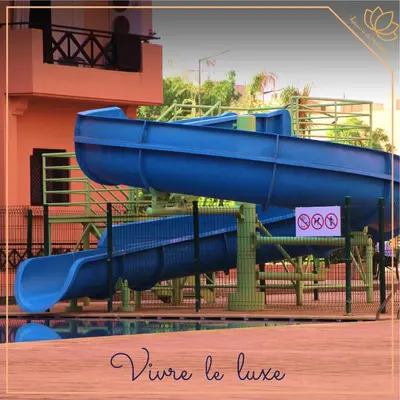 a blue water slide in front of a building at Palmera de Marrakech in Marrakech
