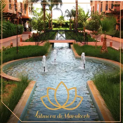 a fountain in a park with people in the water at Palmera de Marrakech in Marrakech
