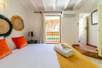 a bedroom with a large white bed with orange pillows at Riad Kasbabouch - Breakfast - 10mn to Jamaa Al Fna in Marrakech