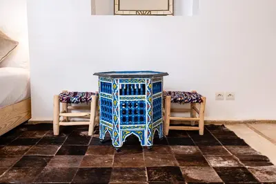 a blue and white table in a room with two chairs at Riad Kasbabouch - Breakfast - 10mn to Jamaa Al Fna in Marrakech