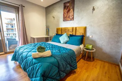 a bedroom with a large bed with a stuffed animal on it at Apartment pool marrakech in Marrakech