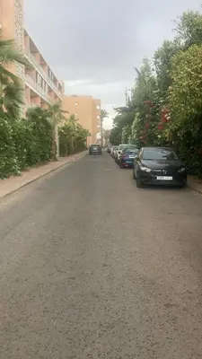 a street with cars parked on the side of the road at Apartment pool marrakech in Marrakech