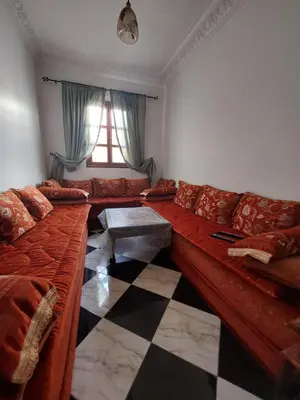 a living room with a couch and a checkered floor at Samsat Apartement House Marakech in Marrakech