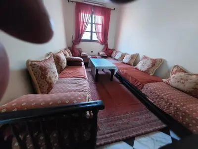 a living room with red couches and a table at Samsat Apartement House Marakech in Marrakech