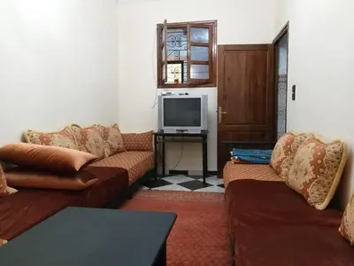 a living room with two couches and a television at Samsat Apartement House Marakech in Marrakech