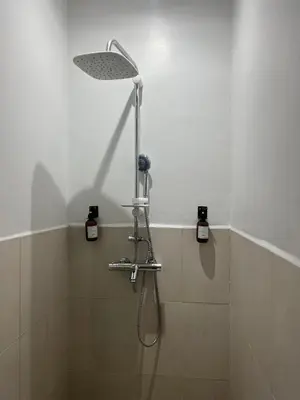 a shower with a shower head in a bathroom at Cosy appartement au cœur de Gueliz in Marrakech