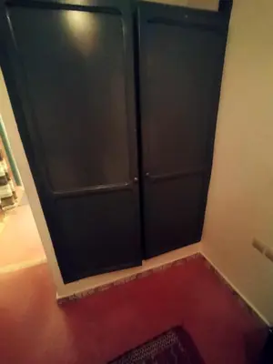 a black door in a room with a red rug at Kesh apartment in Marrakech