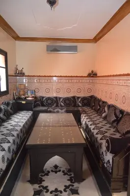 a living room with two beds and a table at JHDARINNA in Marrakech
