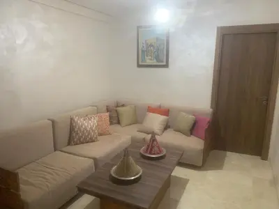 a living room with a couch and a table at Family apart in Marrakech