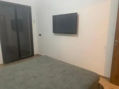 a bedroom with a flat screen tv on the wall at Family apart in Marrakech