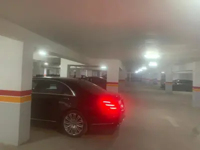 a red car parked in a parking garage at Family apart in Marrakech