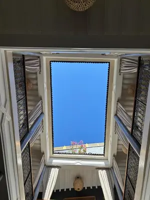 a window in the ceiling of a building with the sky at Riad Al Nubala in Marrakech