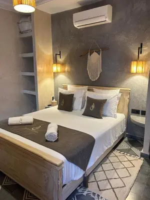a bedroom with a large bed with white sheets at Riad Al Nubala in Marrakech