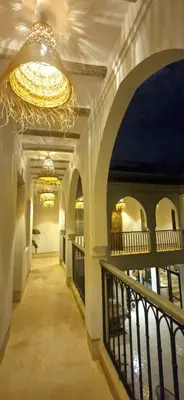 a hallway in a building with a chandelier at RIAD 48 & SPA in Marrakech