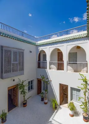 an external view of a house with potted plants at RIAD 48 & SPA in Marrakech