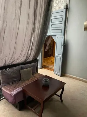 a living room with a couch and a table at BKAN RIAD MARRAKECH in Marrakech