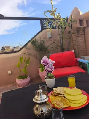 a table with a plate of food on top of it at BKAN RIAD MARRAKECH in Marrakech