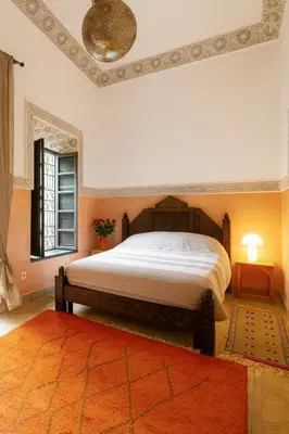 a bedroom with a large bed and a window at BKAN RIAD MARRAKECH in Marrakech