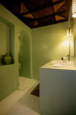 a bathroom with a sink and a counter with a light at BKAN RIAD MARRAKECH in Marrakech