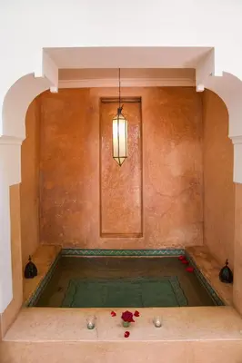 a pool of water with flowers in a room at Riad Dar Zitouna Marrakesh - entire house in exclusivity in Marrakech