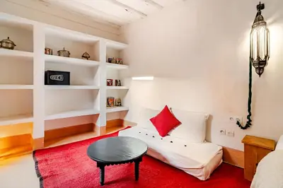 a living room with a couch and a table at Riad Dar Zitouna Marrakesh - entire house in exclusivity in Marrakech
