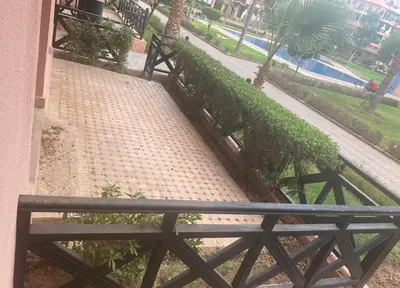 a bench sitting on a sidewalk next to a building at un moderne chic appartement vue sur piscine in Marrakech