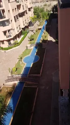 an overhead view of a swimming pool next to a building at un moderne chic appartement vue sur piscine in Marrakech