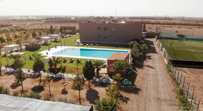 an aerial view of a building with a swimming pool at lafamilia in Marrakech