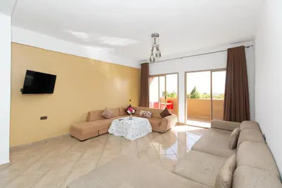 a living room with two couches and a table at lafamilia in Marrakech