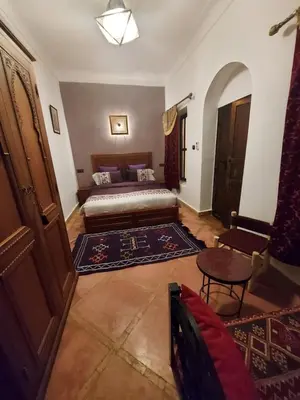 a living room with a bed and a table at Riad dar Karam in Marrakech